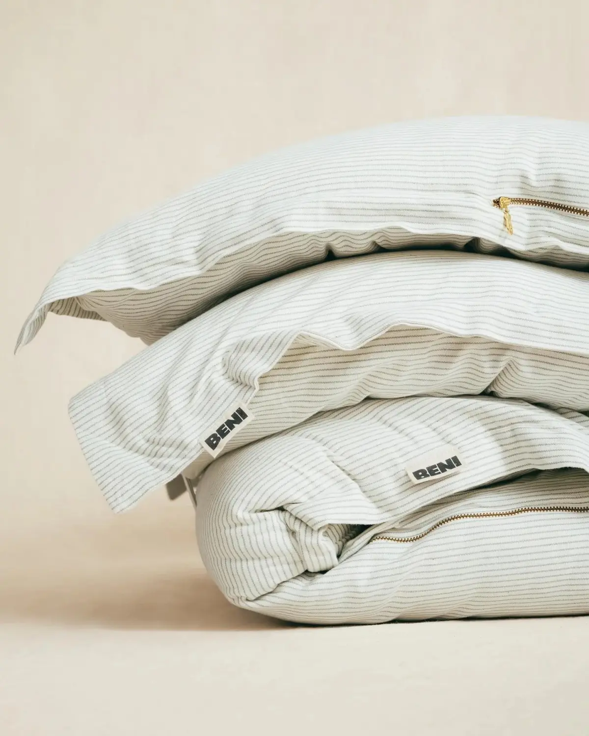 Beni Fabrics striped bedding folded in a stack
